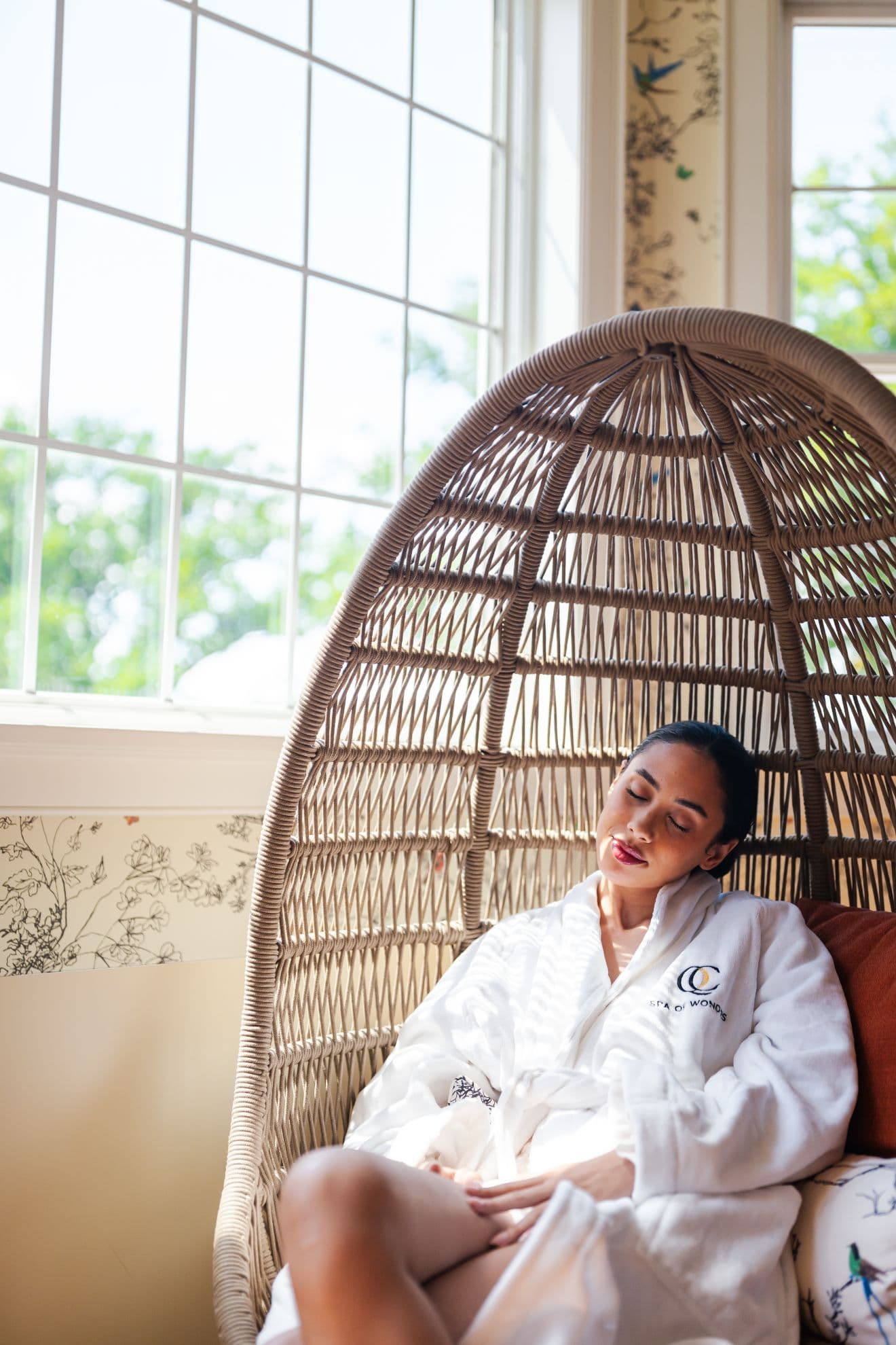 A woman in a waiting room relaxing in a recliner in a relaxation area